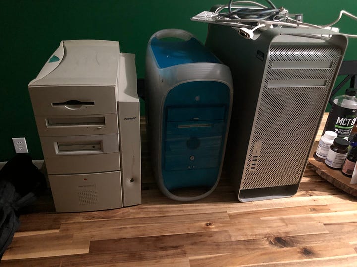 Two photos.  The first is a 21 inch 2007 iMac on a wooden desk with a boot screen, a silver and white keyboard and a Magic Mouse.  The second photo is a beige 1997 Apple Power Macintosh G3 Minitower, a 1999 PowerMac G3 blue & white, and a 2006 Mac Pro all sitting on a wooden table.