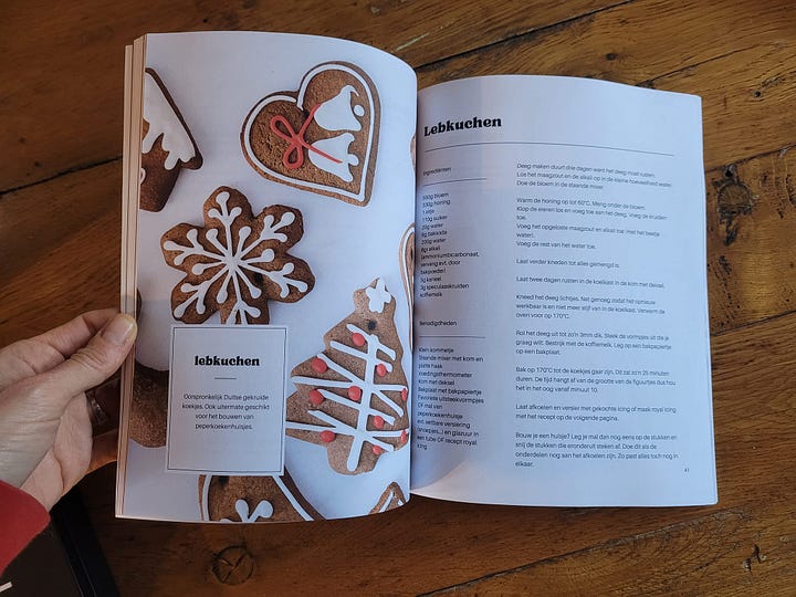left - inside the book; a photo of decorated lebkuchen and the recipe. Right - a photo of a stollen loaf on a grey cutting board.