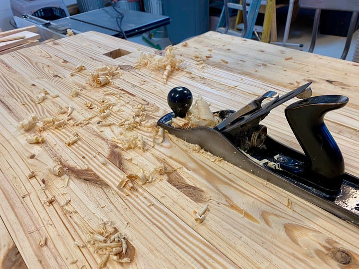 Handplane working a slab of wood; routing a mortise.