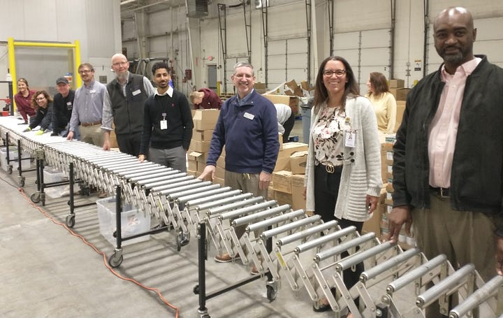 Giant Food's local management and human resources team visited the Fredericksburg Regional Food Bank last week to donate 200 Easter hams and help assemble boxes for distribution. Photos courtesy Fredericksburg Regional Food Bank. 