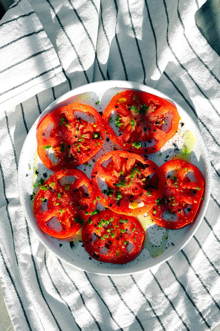 Fresh sliced tomatoes with seasoning. Blackberries on the bush. Photos by Okeykat and Richard Lin via Unsplash.