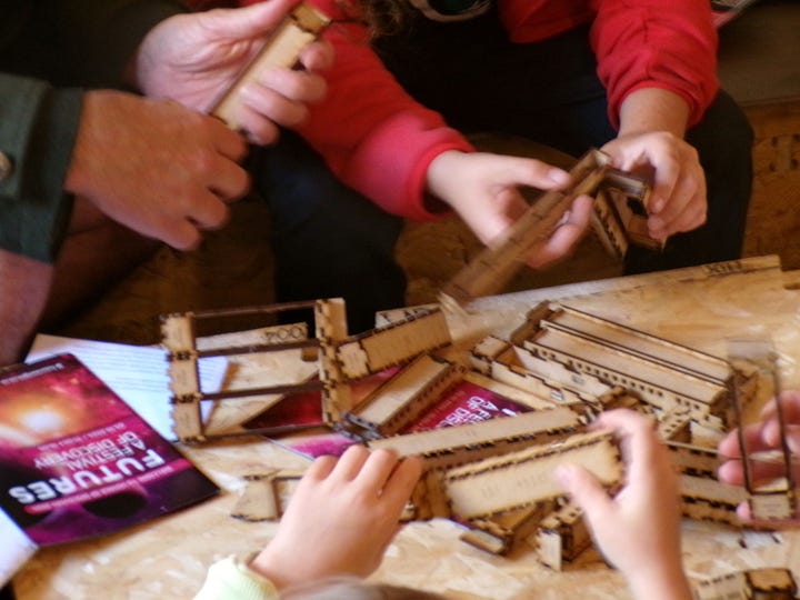 WIkiHouse parts being assembled into a small structure