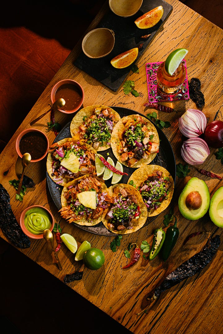 Taco spread with lots of salsas and toppings. Vegan chickpea and lentil tacos with cilantro, avocados, tomatoes, and limes. Photos by ALLAN LAINEZ and Shannon Nickerson, Unsplash