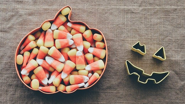 Bowl of assorted Halloween candy; bowl of candy corn