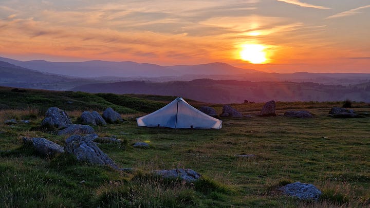 Pictures of a tent in a stone circle. Sunset. Stove with steam.