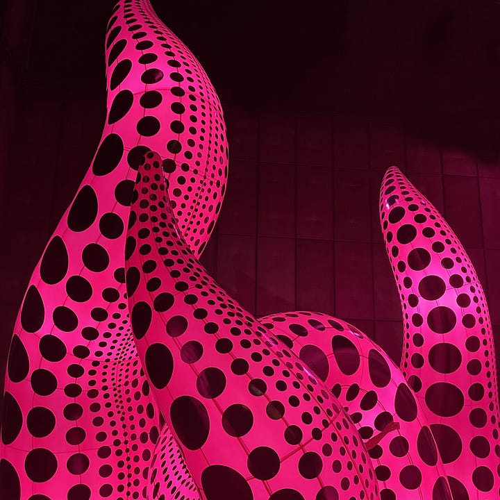 Photographs of giant inflatable doll, dog, and pink and black spotty inflatable art installations.