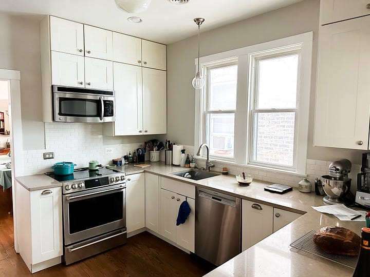 Kitchen with light coloured cupboards.