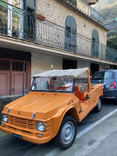 Two orange Citroen Mehari cars, one in Amalfi and the other a model on my desk.
