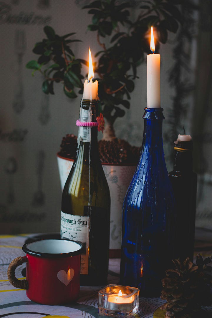 Warm-colored blooms. Wine bottles with lit candlesticks in them. Photos by Unma Desai, Myko Makhlai via Unsplash.