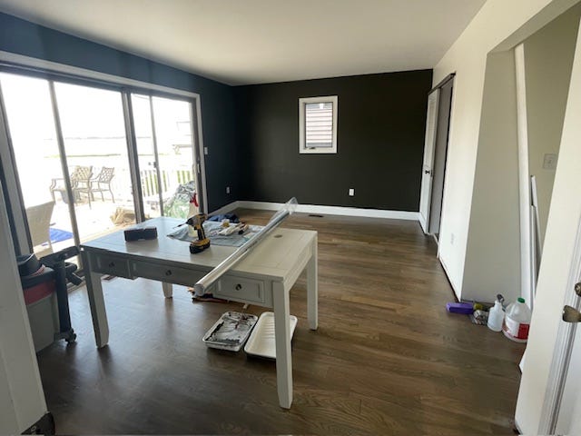 The before bedroom is washed out and doesn't have any focal points. The sliding glass door will end up being the focal point and the dramatic wall color frames the view.