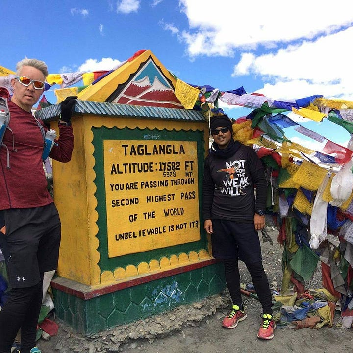 Simon Hollis with marathon record holder Eliud Kipchoge, and at a checkpoint in a race in the Himalayas