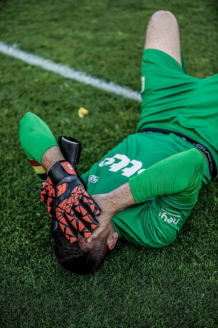 Photos of Royale Union Saint-Gilloise Anthony Moris and Christian Burgess lying on the floor with their hands on their heads after losing on the final day of the 2022/23 season against Club Brugge