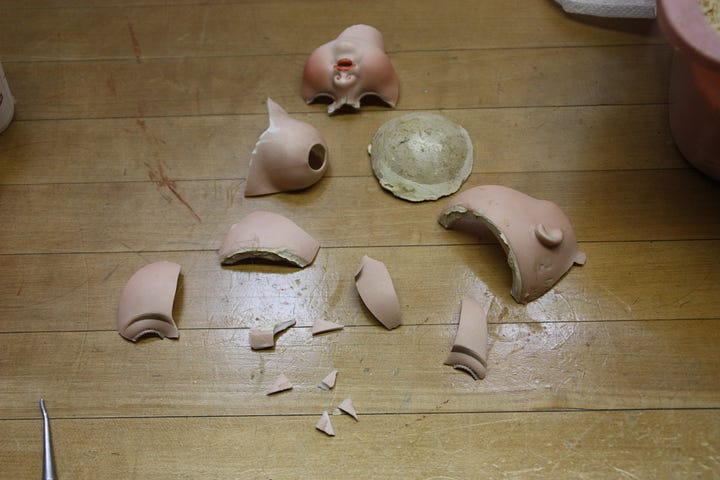 Damaged doll. Broken porcelain head. Broken pieces. 