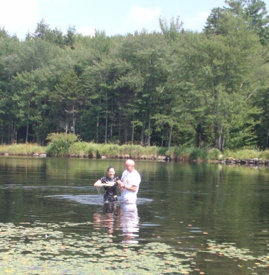 The author being baptized in a lake in summer, 2011.