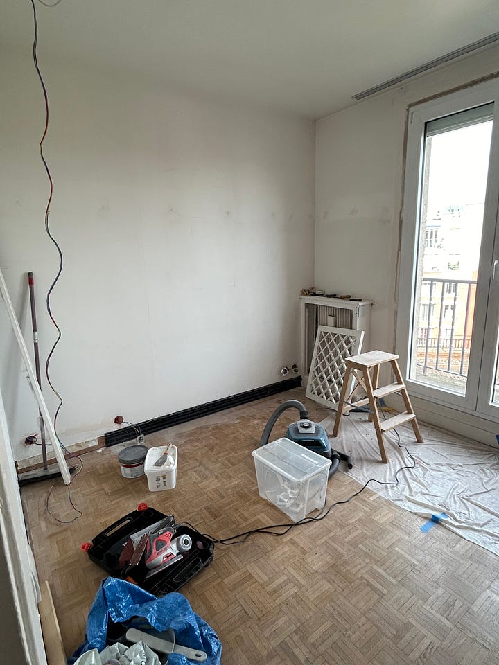 A small room with ladder and an armoire in the middle of a renovation in Paris