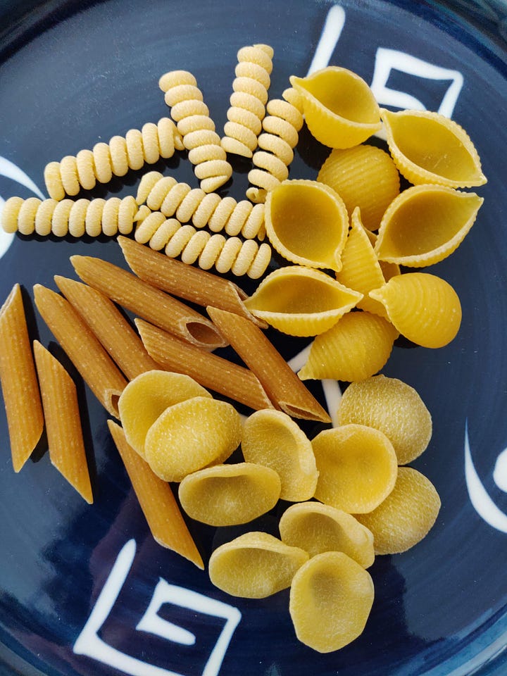 Four images of different pasta shapes, from spaghetti to penne to shells and orecchiette.