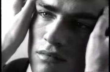 a black and white close up of a man's face and eye