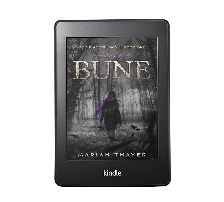 E-readers with the covers of Defiance and Bune by Mariah Thayer on the screen. Defiance features a woman in a leather jacket in the forest with the full moon looming behind her, a wolf at her side. Bune features a woman with short hair wearing a jacket, boots, and scarf walking through a foreboding gray, foggy forest scape.
