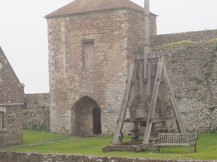 Two images of replica trebuchets at Dover Castle.