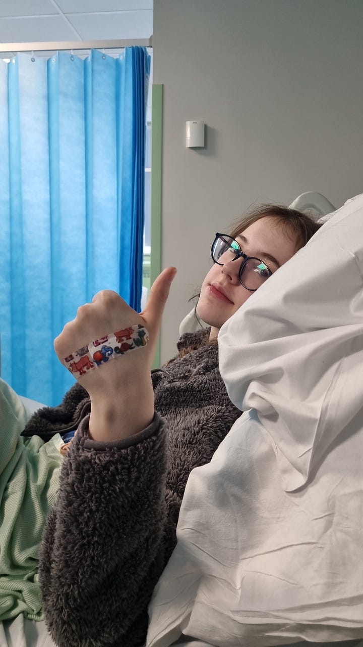 Avalyn with children's book and in hospital for treatment
