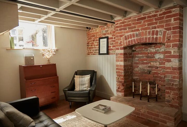 Original exposed red brick work in the living areas of both the living room and bedroom