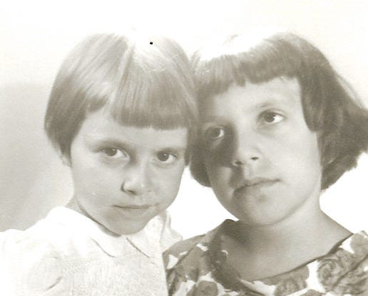 Two little girls, sisters, with 1950s bobs.