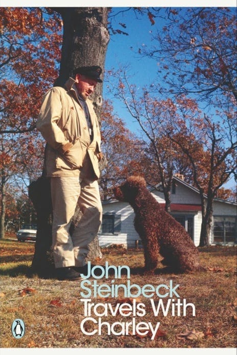 Left: John Steinbeck, left, leans against a tree outside his home in Sag Harbor, New York. His poodle, Charley, to his right, looks up at him. Cover of an early 1960s Penguin edition of Travels with Charley in Search of America. Right: A modern Penguin Classics edition of Travels with Charley. Charley holds his head out the window of Steinbeck's green pickup camper, Rocinante, as the pair cruise down the road. 