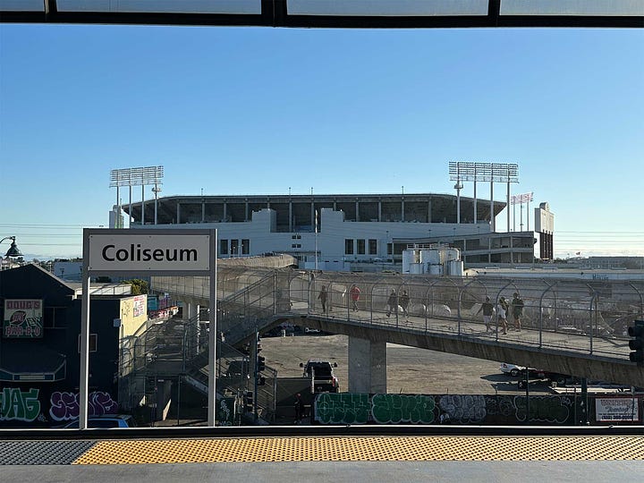 Exterior view of Coliseum from train station, and view from seat with blocked view due to seats on the level above.