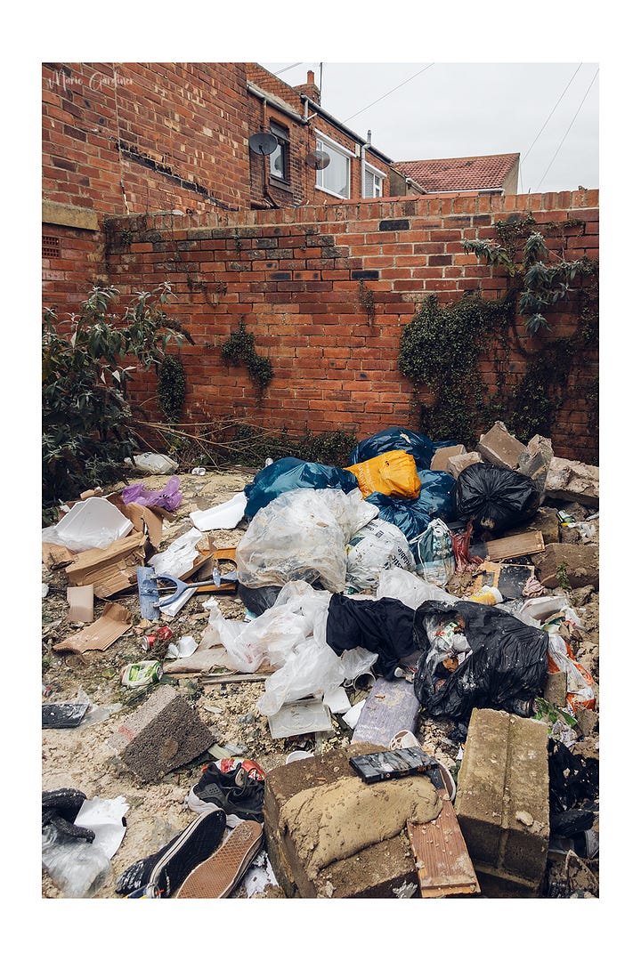 Empty property which has been burnt out and fly tipped