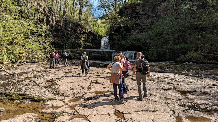 waterfalls and hikers in the brecon beacons with wales outdoors