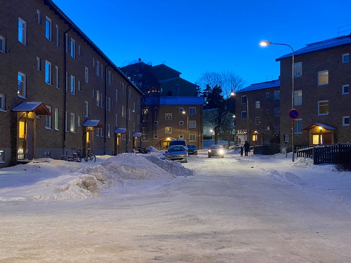 The streets in Stockholm piled with snow at dusk