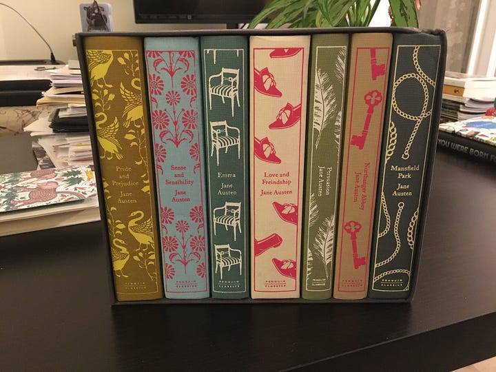 Seven multi colored clothbound books in a printed box. 