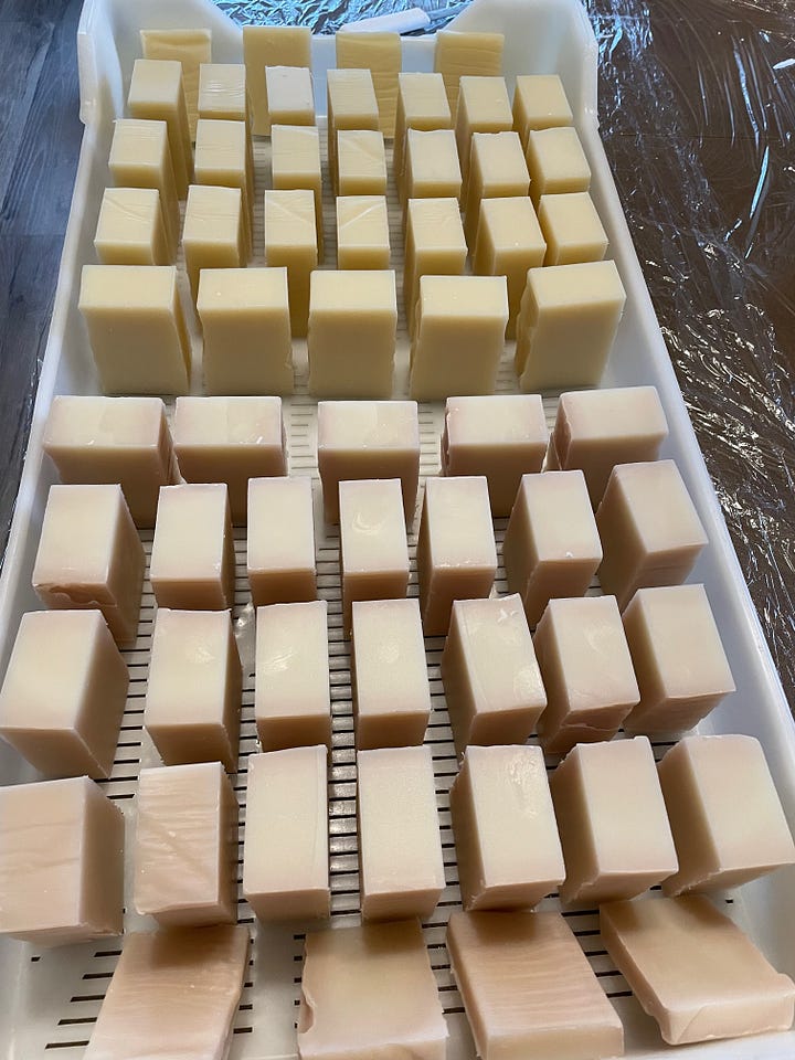 batches of soap on drying racks 