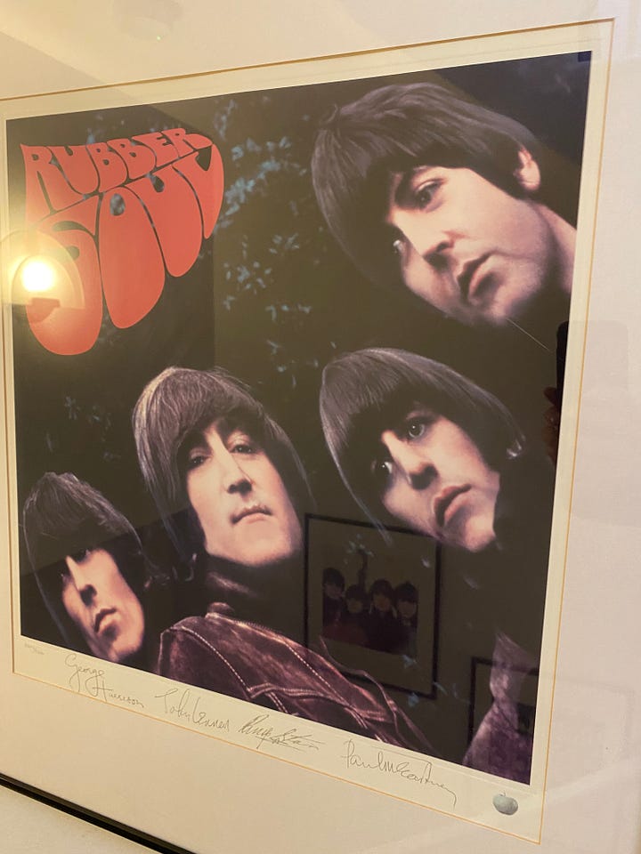 picture frames of Beatles album covers and photographs of Liam & Noel Gallagher and David Bowie.  