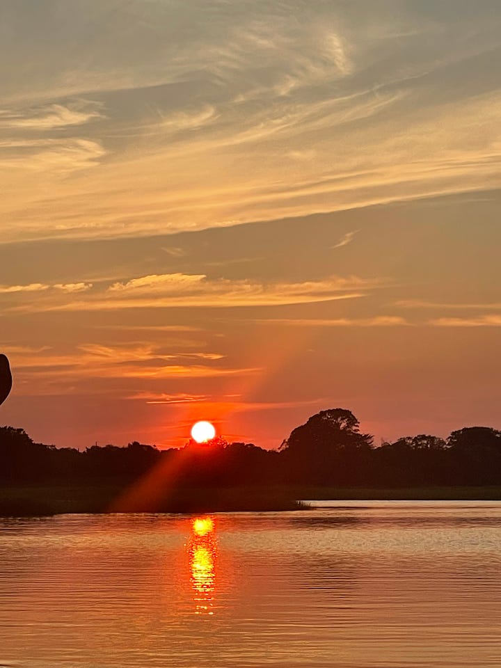 Sun and moon over the marsh while kayaking