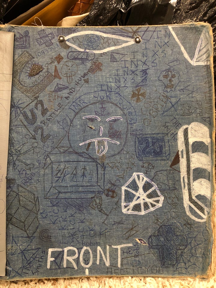 Two cloth-covered three ring binders covered with a highschoolers doodles