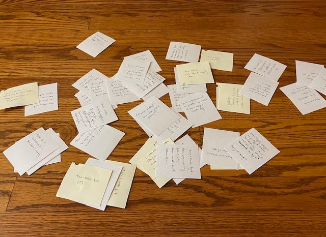 A notebook and small notecards in a pile on the floor, and then two images of the notecards arranged in a neat order across the floor