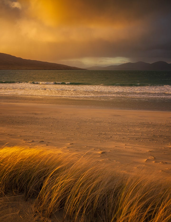 Images of sunset over the beach at Luskentyre, Isle of Harris, Scotland, including gorgeous warm light and a rainbow over the Harris Hills