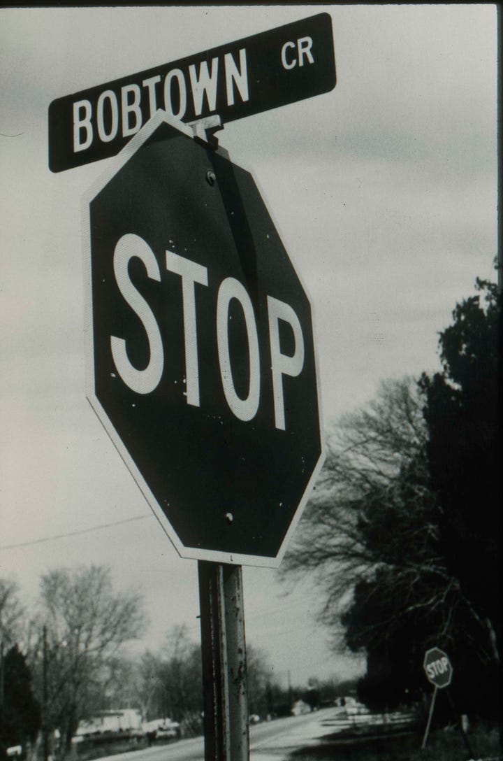 Left: Bobtown Circle stop sign, 1987. Right: Roland Charles stands next to a stop sign in Bobtown. Roland Charles Collection © Tom and Ethel Bradley Center. 