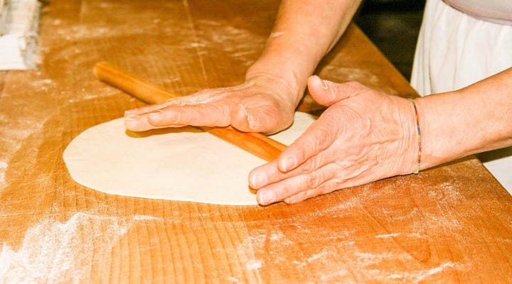 rolling out dough for pane carasau