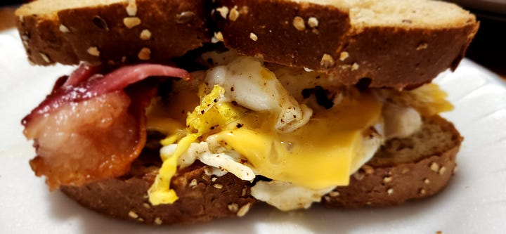 pictured are different shots of a bacon, egg, and cheese sandwich on multigrain bread.
