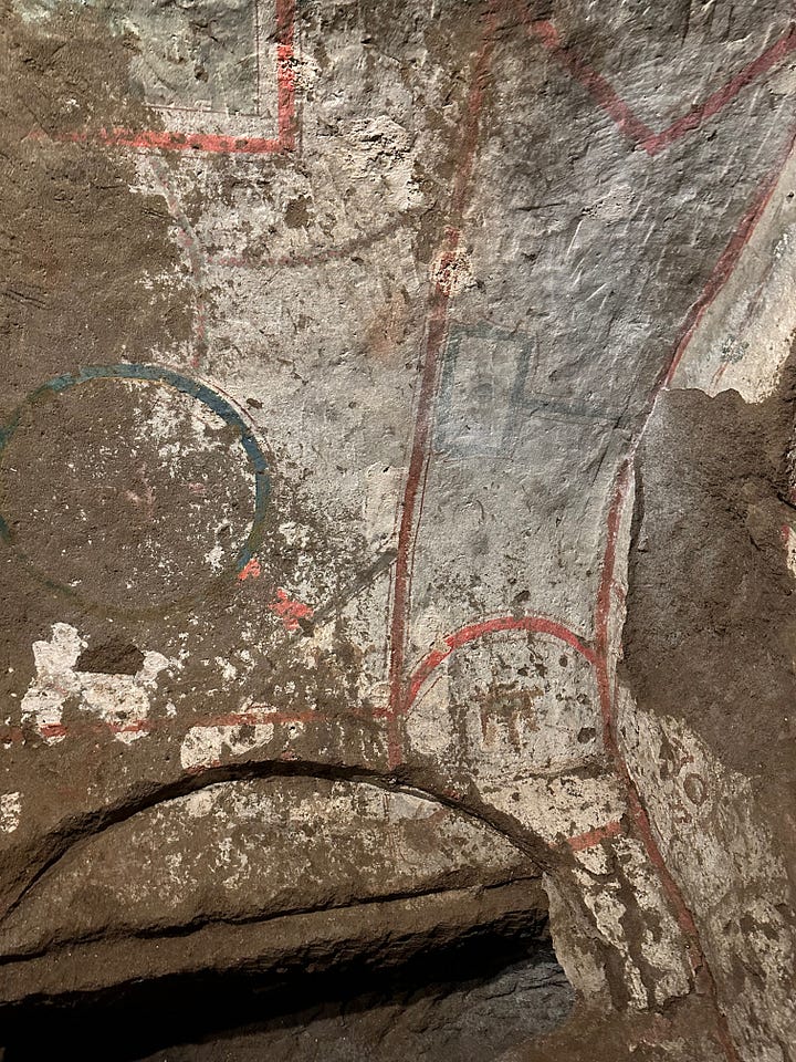 Decoration and utility in the catacombs. 1 and 2 are painted surfaces. 3 is an oil lamp in the shape of a fish embedded in the wall. 4 is more likely the name of the manufacturer of the earthenware slab than the name of the person who was buried there.