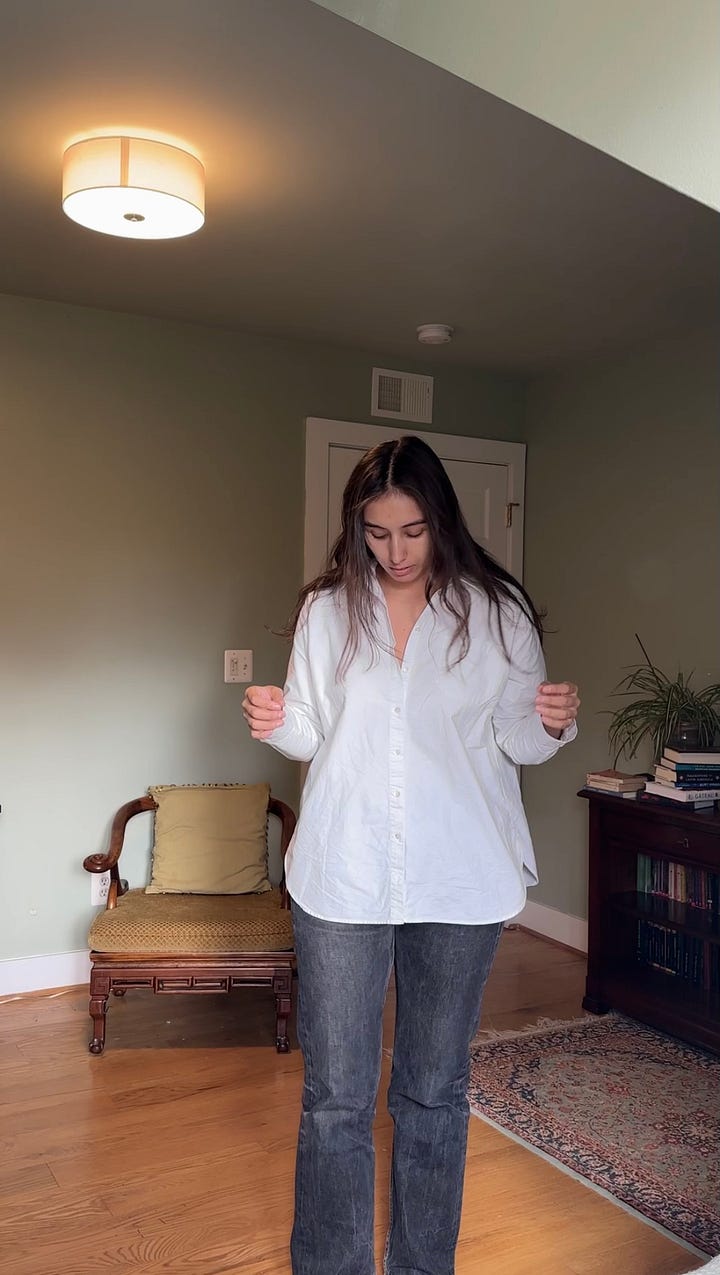 woman standing in white button down