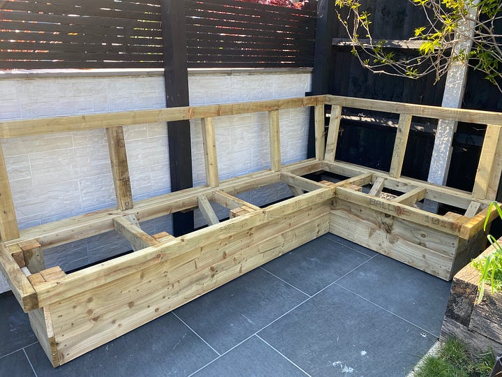 wooden slats added to the seating frame to create a seated area, one photo showing the initial process and the second showing it complete and painted in black