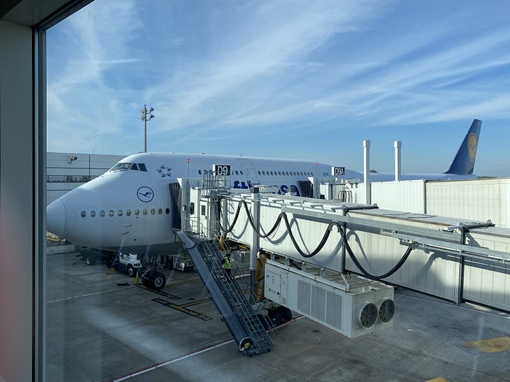 Lufthansa Boeing 747 parked at IAH airport and upper deck Business Class seat