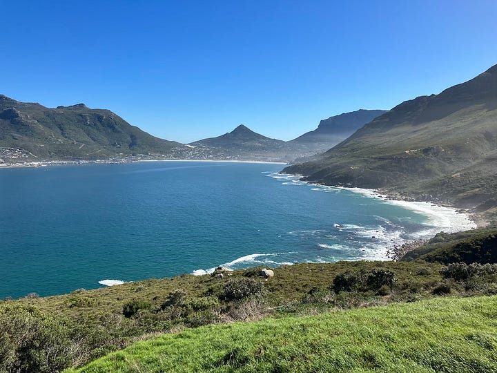 View of white sand, clear water and mountains