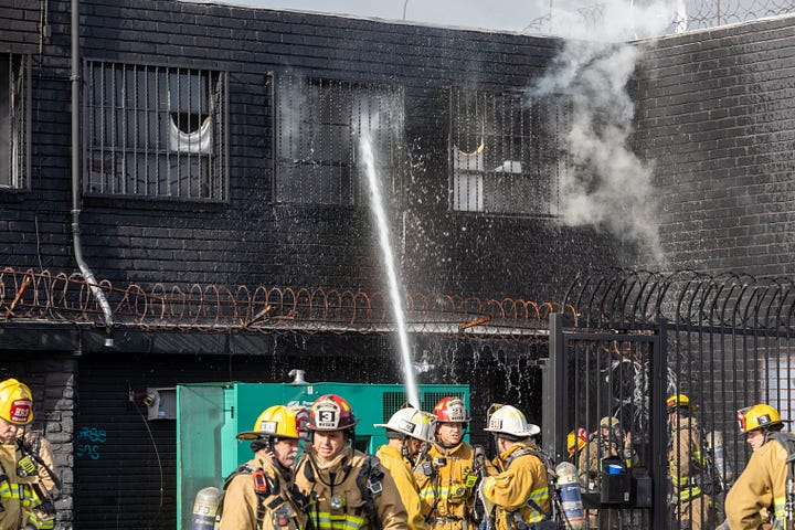 images of firemen working a fire in downtown LA's produce district