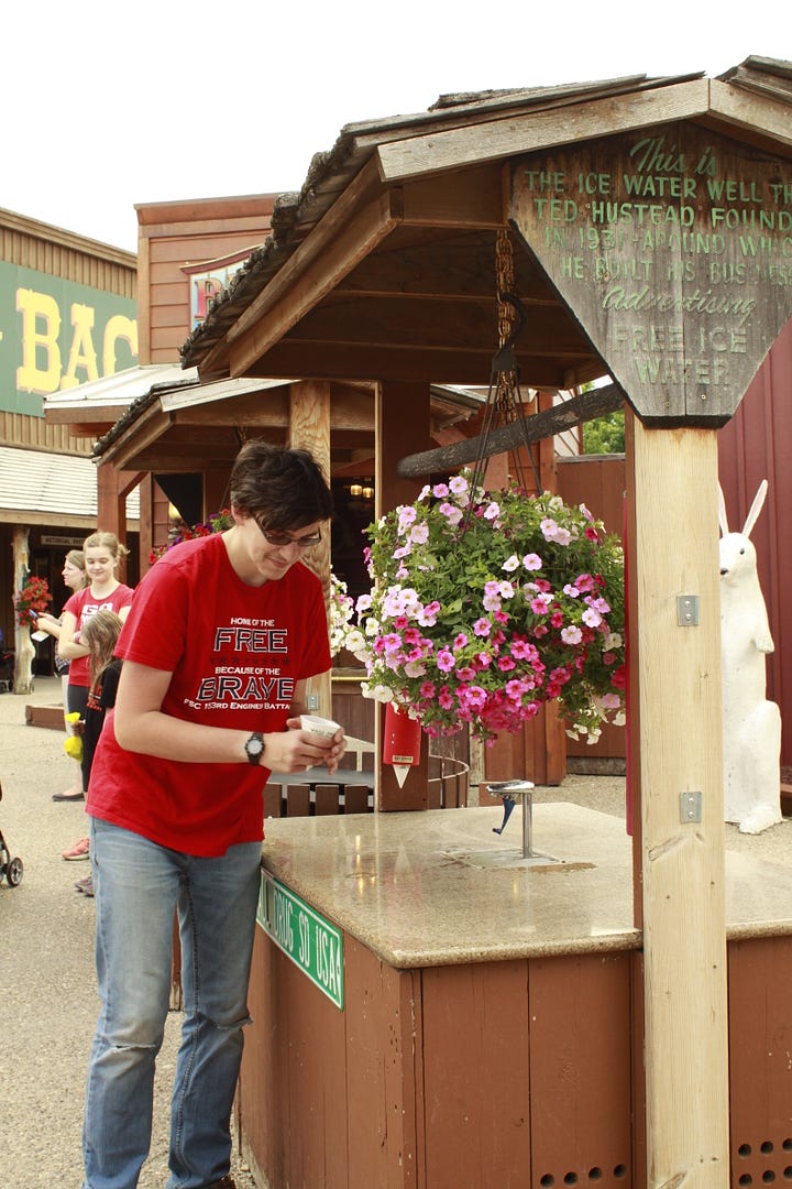 A photo of a girl on a statue of a jackalope, two photos of a boy and a girl getting cups of water, and a boy drinking water from a cone shaped cup.