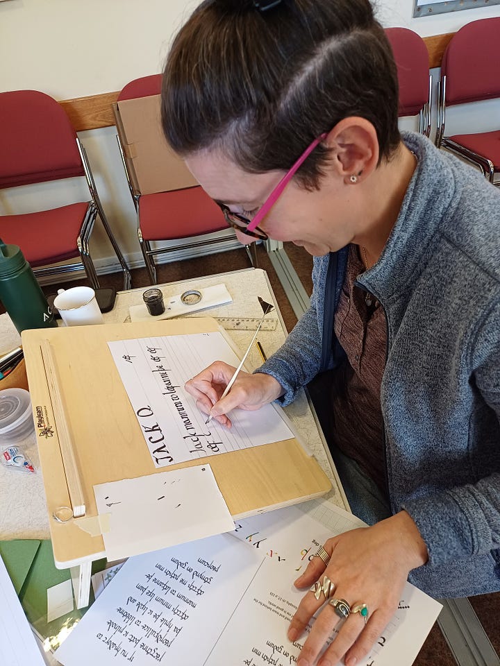  A bearded man wearing glasses is focused on writing on a sheet of paper at a desk; A woman diligently writes on a piece of paper, focused on her task with a pen in hand; A group of individuals gathered at tables, engaged in discussion with papers and coffee cups in front of them; A classroom scene featuring individuals seated at tables, engaged with papers and pencils for learning activities.