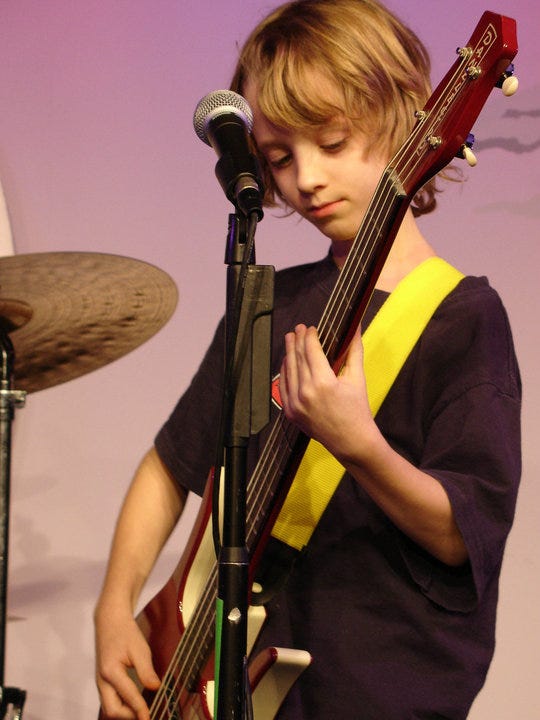 Henry playing bass and me playing drums at Second City Letters to Santa benefit sometime in the early 2000s.